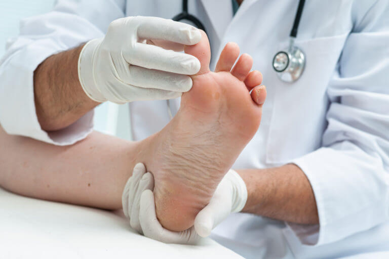 Foot specialist examining the athlete foot