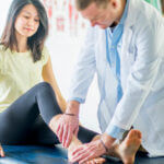 Woman with an Ankle Injury examined by foot & ankle doctor