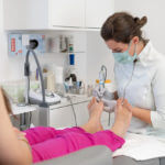 Female podiatrist working on foot care